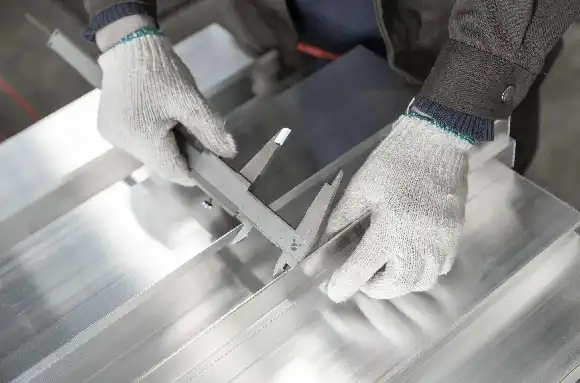 Quality inspector verifying aluminum tube dimensions at partner mill